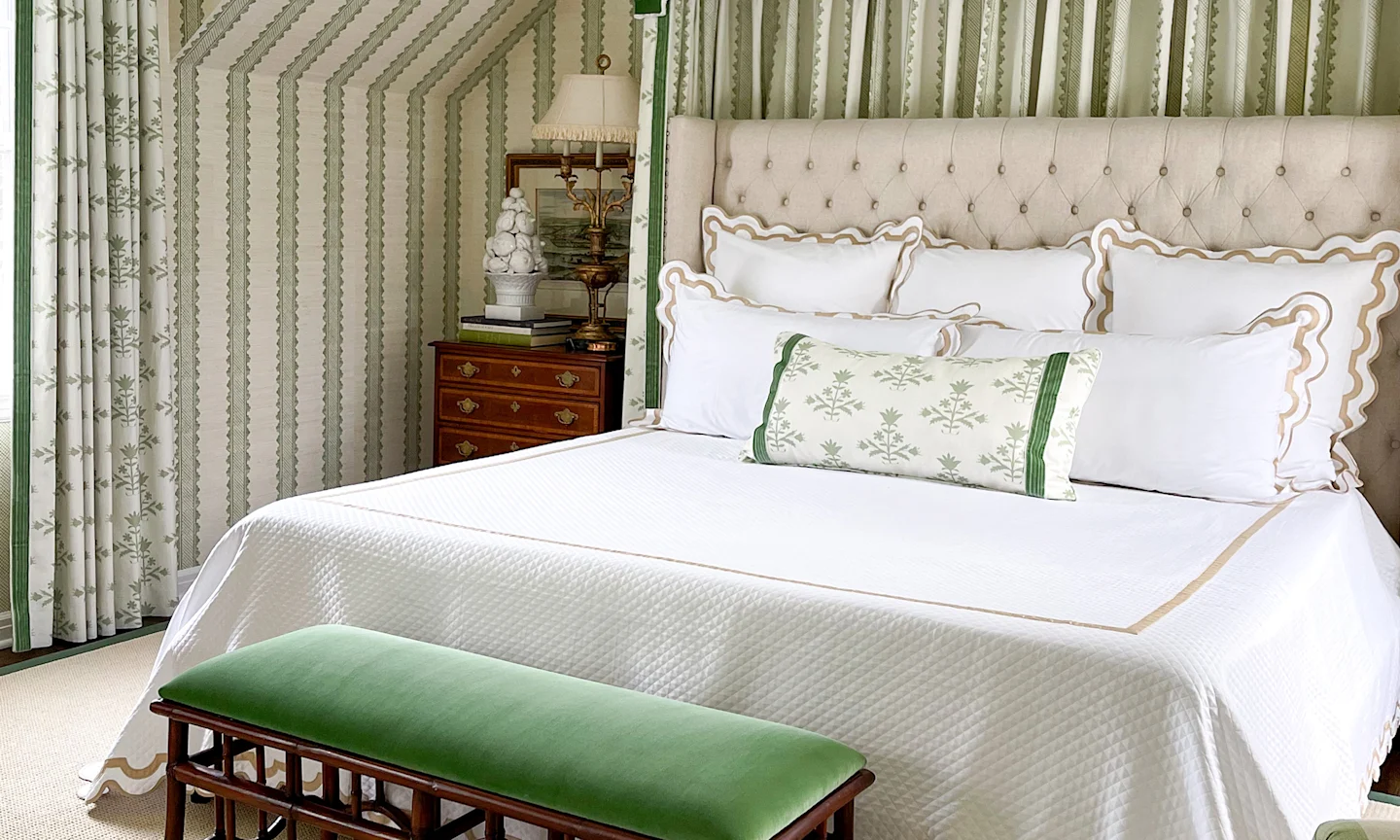 Bedroom with green and cream wallpaper, curtains and a headboard made out of Spoonflower fabric.