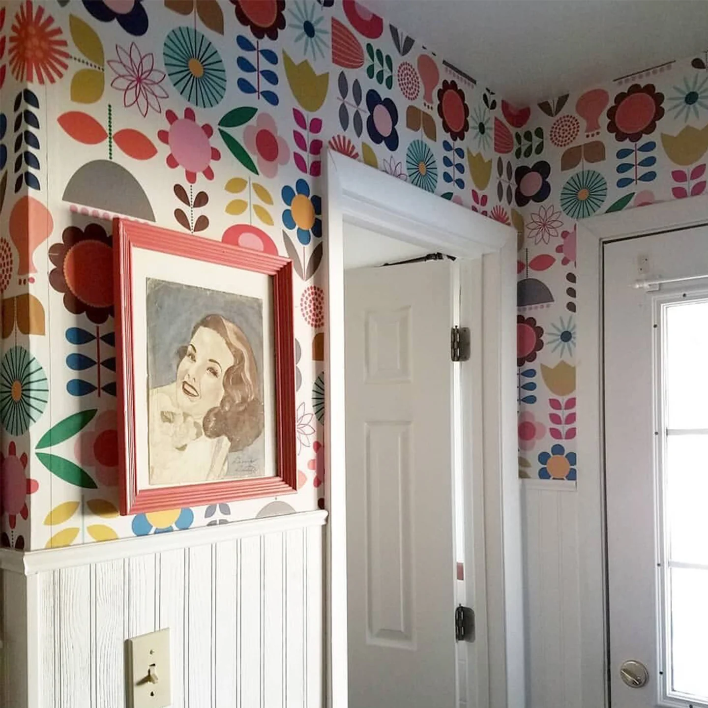 Entryway with mid century modern floral wallpaper.