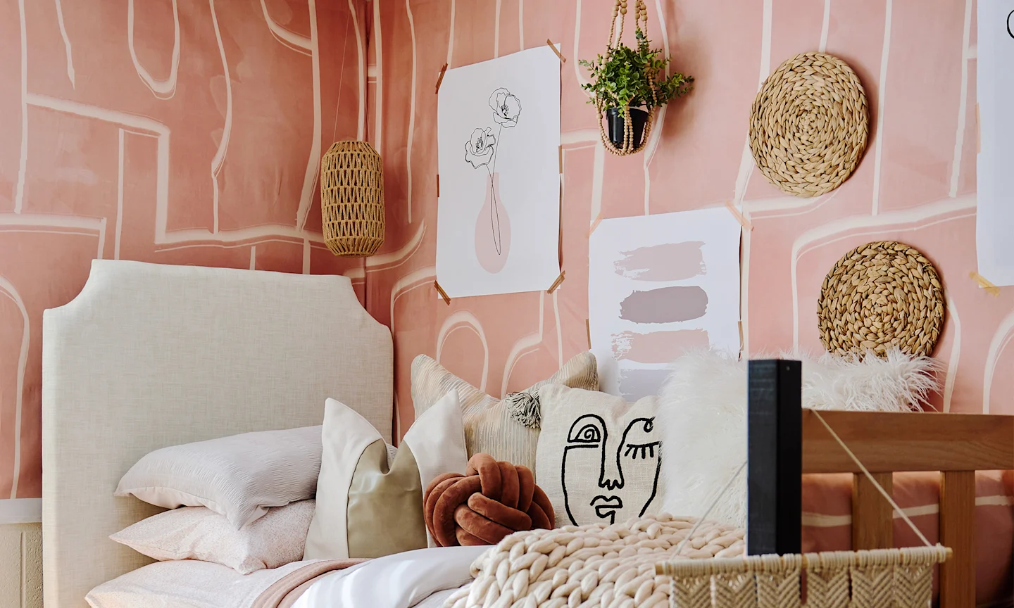 Dorm room with pink peel and stick wallpaper.