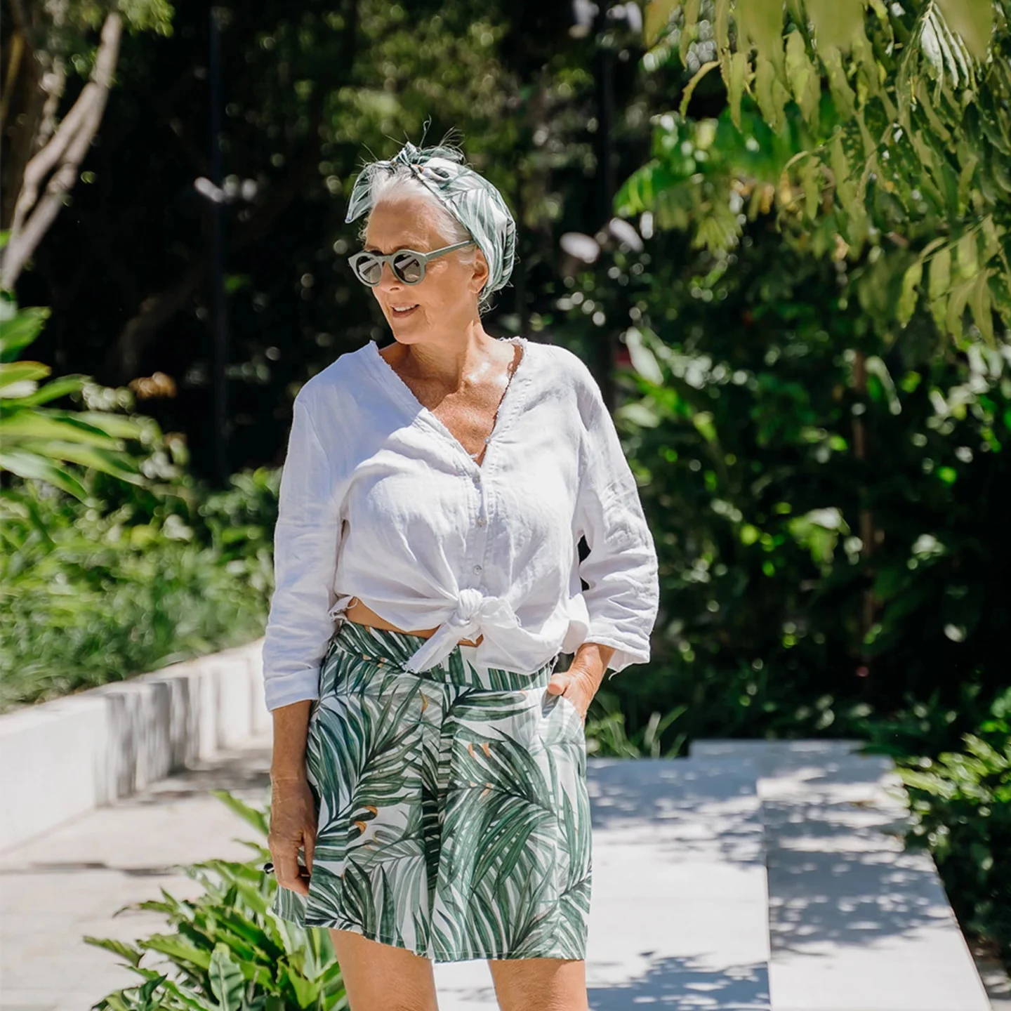 Woman wearing green palm leaf printed shorts