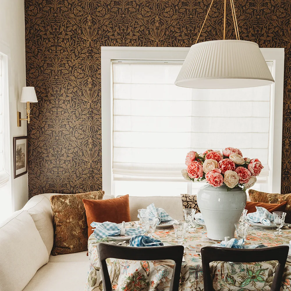Dining area with wallpaper in a dark acorn William Morris inspired design by Spoonflower artist salvagescapes. 