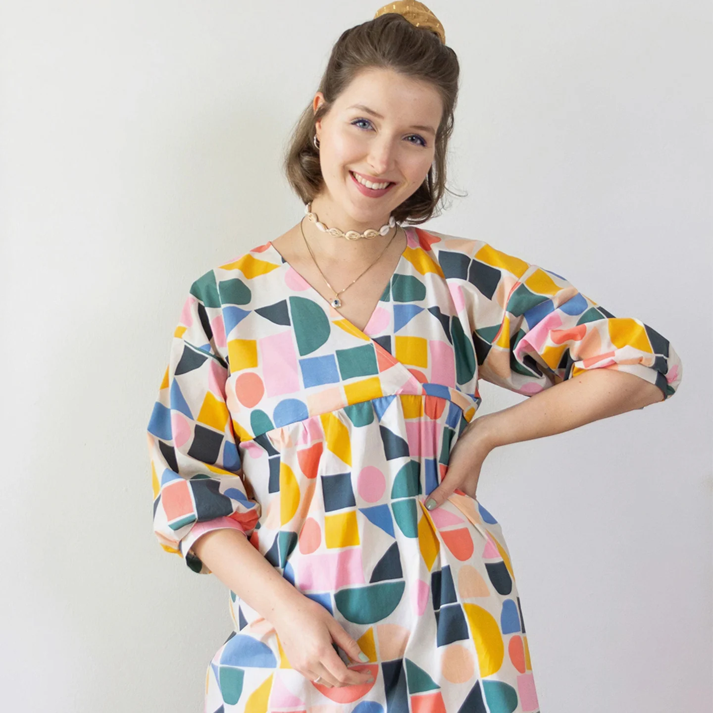 Woman in colorful geometric dress.